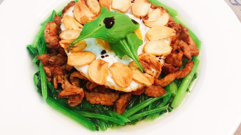 蒜香菠菜肉丝,在菠菜上铺上炒熟的小里肌肉丝,再摆上蛋,延着蛋的周围,摆上蒜片,并将刚预留的两片菠菜摆上,点几滴红酒醋,即可享用喔~