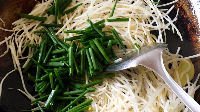 香葱炒银牙(豆牙),翻炒几下就把切成断的葱放进去,放盐