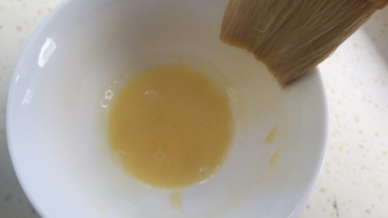奥利奥蛋黄月饼(50克),蛋黄一个和10克水调匀,用羊毛刷沾一丁点,涂在月饼花纹表明即可。涂好后,月饼放入烤箱中层继续烤10分钟出炉。
