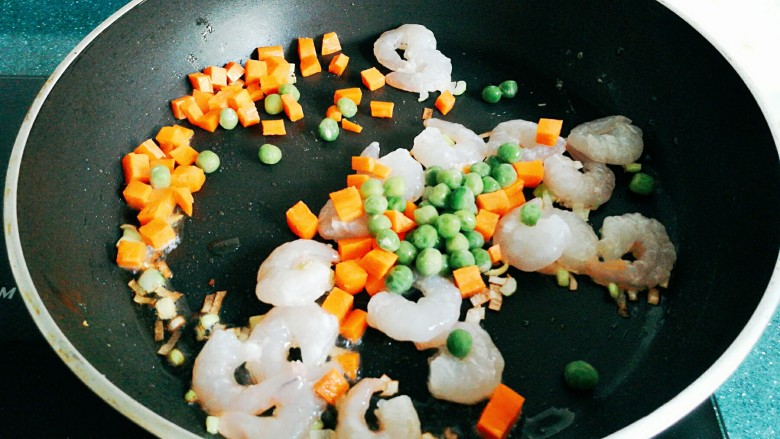 炒虾仁,放入胡萝卜丁、黄瓜丁和<a style='color:red;display:inline-block;' href='/shicai/ 148'>豌豆</a>翻炒。