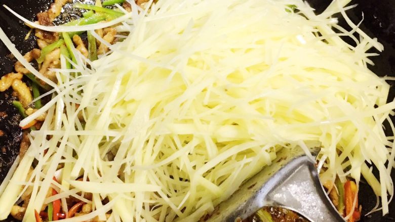 #家常菜大比拼#香辣土豆丝炒肉,倒入土豆丝翻炒。
