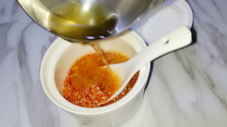 油泼辣子,用铁勺舀适量油浇在辣椒粉上,快速搅拌均匀
