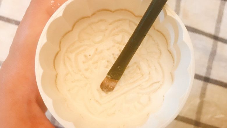 广式莲蓉蛋黄月饼（独家超细致版）,用毛刷在月饼模具上刷一层薄面粉，将模具在桌子上轻磕几下，去除多余的面粉。