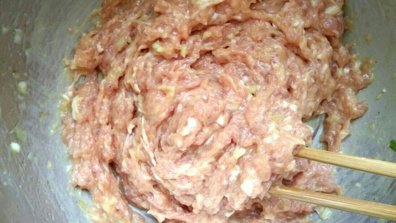 肉馅烧饼,朝一个方向划圈搅拌均匀，为使肉馅鲜嫩，打点儿水继续搅拌细腻