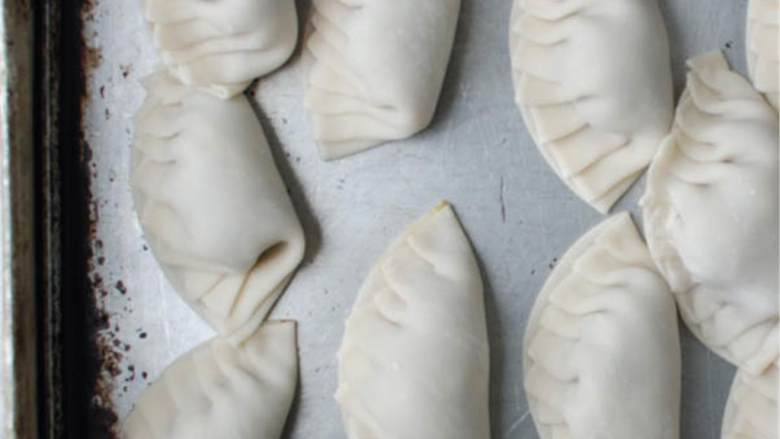 亚洲猪肉水饺,饺子放在干净的盘子里,继续做其他的 。