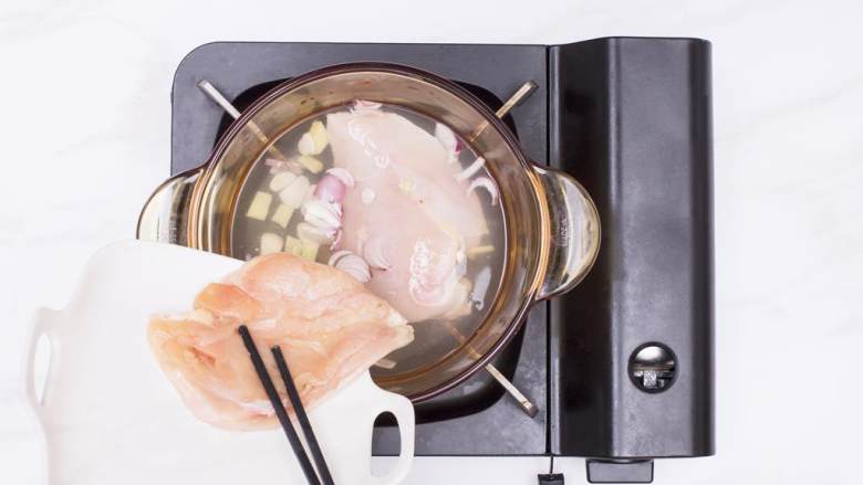墨西哥风味鸡肉配麻酱乌冬面,鸡胸肉 化冻后放入锅中,加入1000毫升水,大火煮开后转小火,加入洋葱片、姜片和蒜片,撇去泡沫,煮至大约20分钟后捞出鸡胸肉沥干备用(汤不要倒)。
