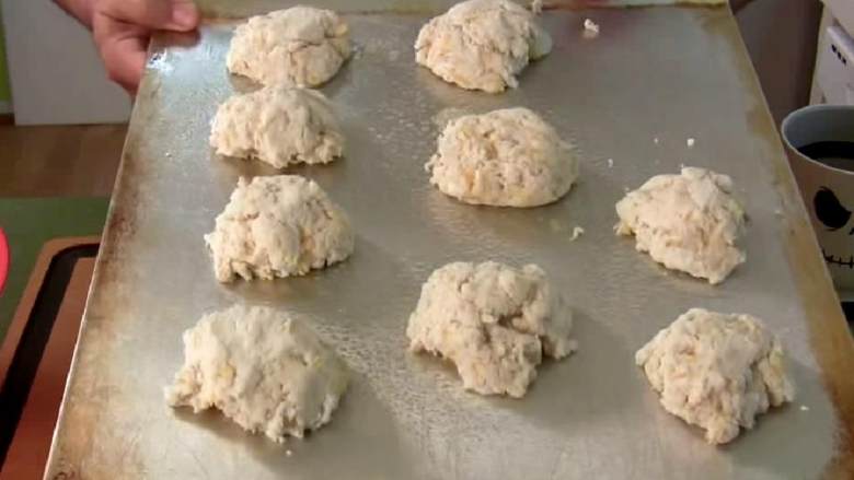 切达干酪龙虾饼干,用勺子将面团一团团放在涂好油的烤盘上,放平稳以防顶部烤太硬。烤10-13分钟直到顶部变金黄色。