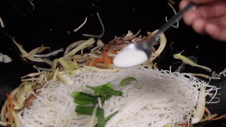 猪肉炒粉,加入米粉和洋葱绿色部分。加入绍兴酒(50克),盐(1 / 2茶匙),糖(3 / 4茶匙),白胡椒(1 / 6茶匙)和鱼露(2茶匙)。搅拌30秒,但不要破坏面条形状。