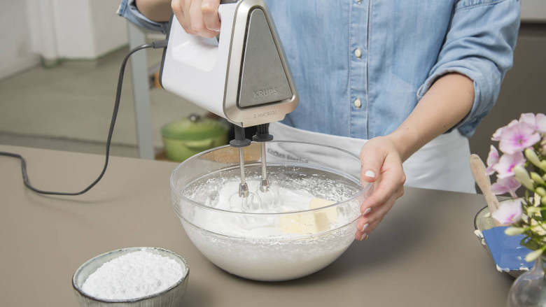 婚礼纸杯蛋糕,Cut remaining butter into small pieces. Incorporate little by little into stiff egg whites. Add confectioner’s sugar and keep beating until cream is homogenous and shiny. Place nozzle in piping bag and fill with frosting.