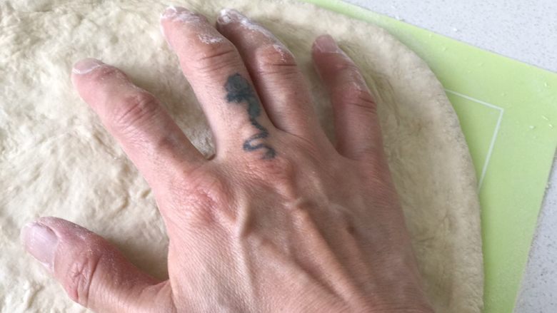 蘑菇披薩,本來錄了一段視頻,教大家怎麼不用擀面杖,用手就可以撐出披薩餅皮,但發現視頻傳不了時,所以已經⋯⋯晚了,湊和用這兩張圖看吧⋯⋯請忽略這只手😂
我盡量說的詳細一點,面團放到案板上用手壓扁,然後用兩手的大拇指和食指擠出餅邊,之後用兩只手的手指部分按壓中間的面團,盡量讓中間的部分平整下去,然後用兩只手在中間做撑餅餅的動作,目的是為了將中間的面皮撑薄讓餅皮變,就像圖片里手的動作一樣,但是不要碰到餅邊。