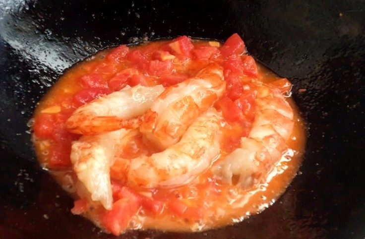 百塔西红柿:海鲜大红虾意面,大红虾加入锅炒,少许<a style='color:red;display:inline-block;' href='/shicai/ 3729'>白糖</a>,视情况再加少许水,盖上锅盖小火焖煮2、3分钟。