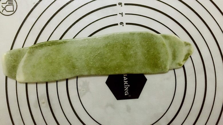 蛋黄千层酥,取出一个醒好的卷第二次用擀面杖擀成长矩形,从上至下卷成卷。