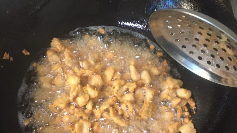 香辣鸡米花,将食材放进5成油温的油锅中慢慢炸,因为肉是生的,要多炸一会