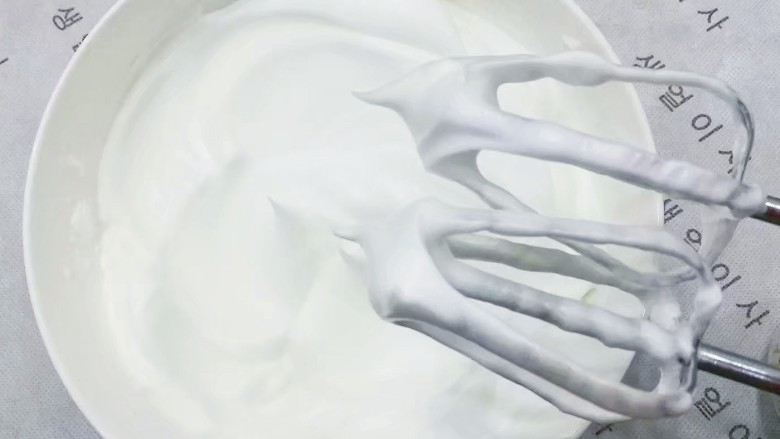 迷彩戚风蛋糕,然后继续打发,并分次加入剩下的白糖,直至提起打蛋器蛋白能拉出一个短小直立的尖角,就表明达到了干性发泡的状态,可以停止搅打了;