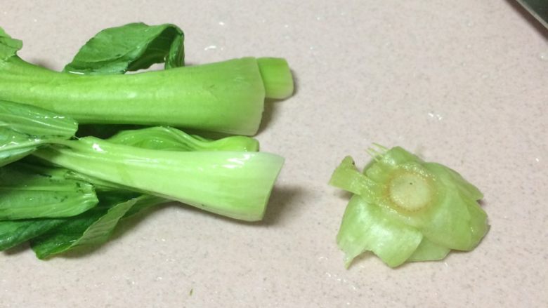 辅食鸡蛋蔬菜粥,洗干净的小油菜切去根部,不管是油菜还是白菜等等,为了健康这个根部一定多去一些