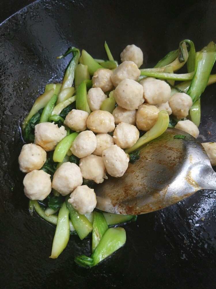 超级简单的油菜鱼丸,倒入煮熟了的鱼丸再翻炒,因为鱼丸是咸的,耗油也是咸的,就不用放盐了 ,如果口重就放一克盐吧。翻炒均匀就可以了。
