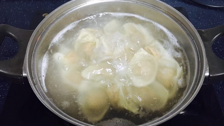 #咸味# 地方特色海鲜汤小云吞 ,放入小云吞,用小勺轻轻推动小云吞的底部,避免粘锅。