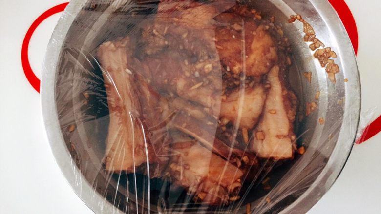 香煎蒜蓉黄金骨,盖上保鲜膜冰箱冷藏至少半天,最好隔夜