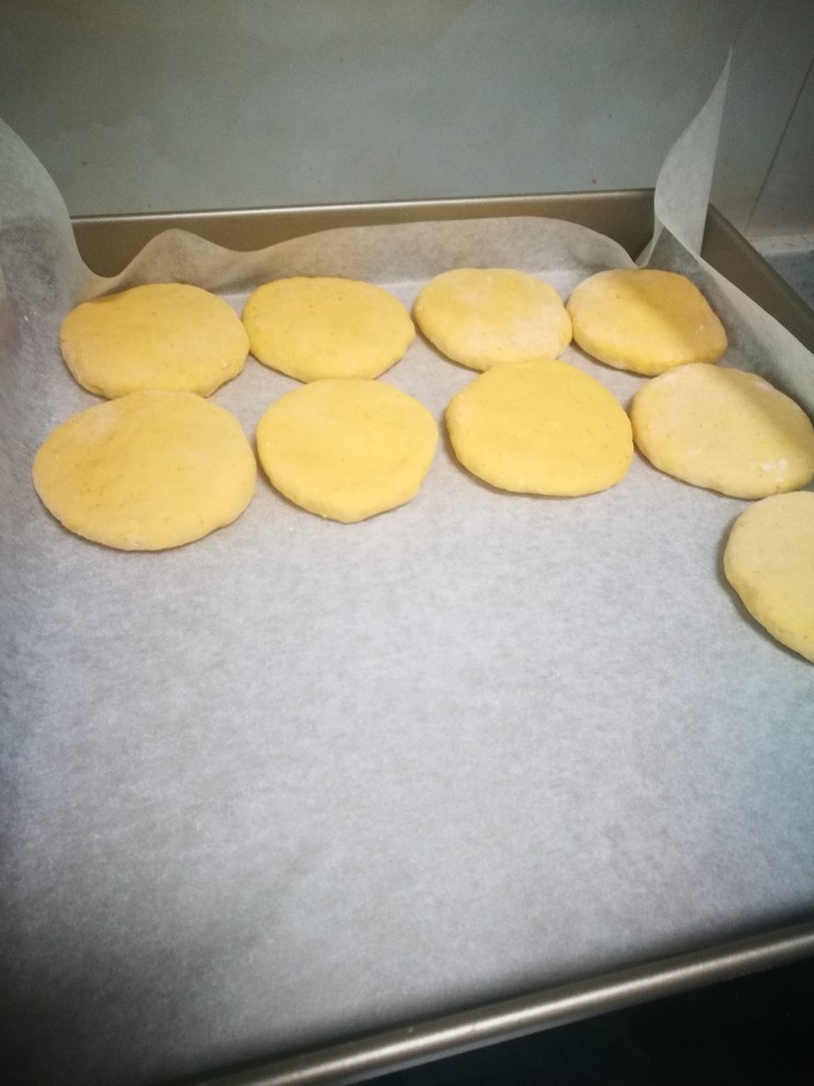 柿子饼,擀制成如图的面饼,这个过程要是粘手不好取,那么擀每个面团案板散上干面粉,为了让我们更容易从案板取下而不破坏擀制好的形状。