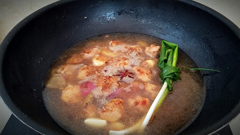 鸡中翅烧土豆,加入热水,莫过食材,放入葱结。
