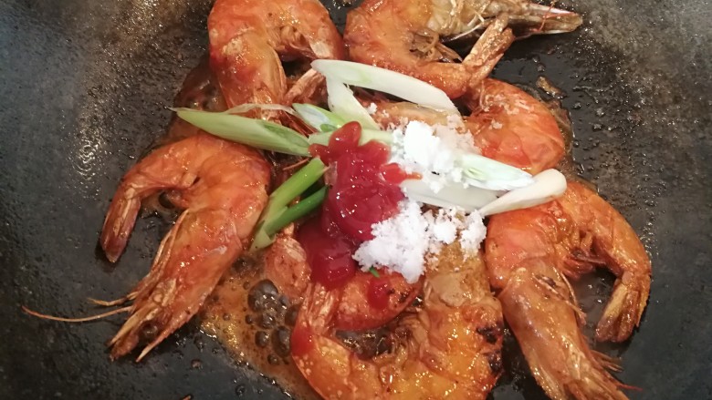 美味红烧虾,两面都煎好后放入葱,番茄沙司,白糖。翻炒一会儿。