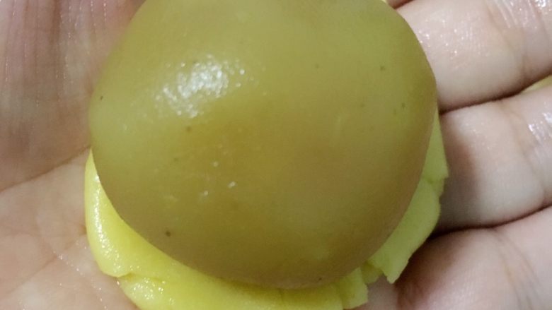 广式月饼——莲蓉蛋黄馅,然后加入一颗馅料,用虎口一点点把饼皮慢慢的推上去