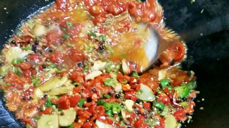 贵州风味鱼火锅,把西红柿炒软,用铲子压碎。