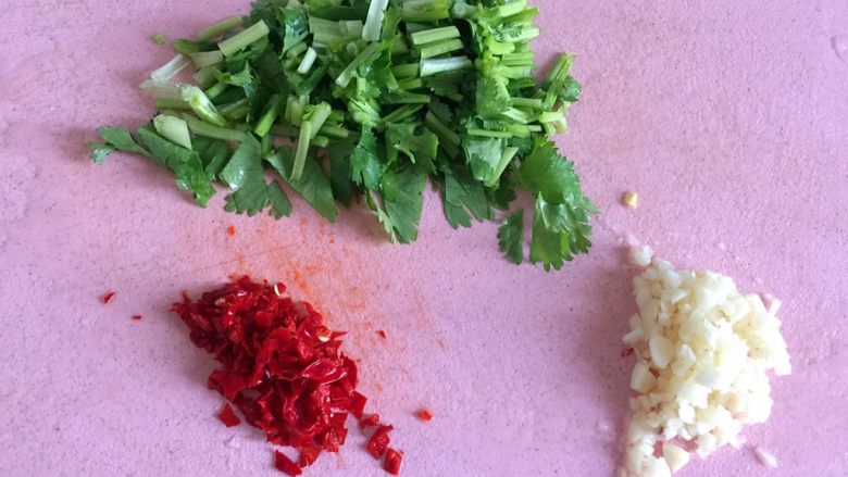 鲫鱼炖豆腐,准备撒料,红辣椒和大蒜切末,香菜切段。