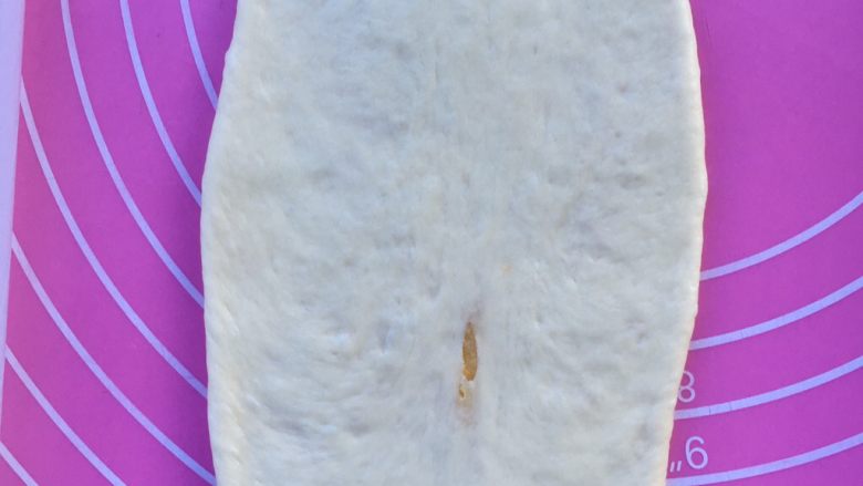 椰蓉心形面包,擀开一个包好馅的面团,成橄榄形