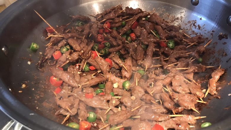 孜然牙签牛肉,所有的肉均已成熟变色,加入青红椒圈,姜碎翻炒均匀;