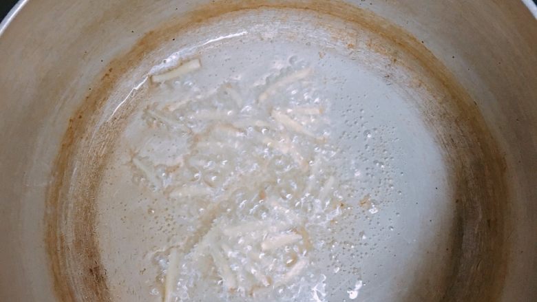梅花肉煮米粉,锅内倒入少许猪油(没猪油可以改用调和油)放入姜丝炸香