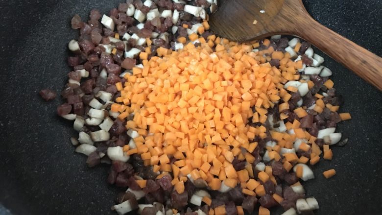 广式烧卖~腊味与海味的完美结合,加入红萝卜粒,炒匀