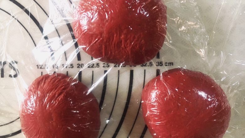 红丝绒全麦麻薯软欧(手揉出膜),均匀的分成3到4份。揉圆盖保鲜膜松弛15分钟。