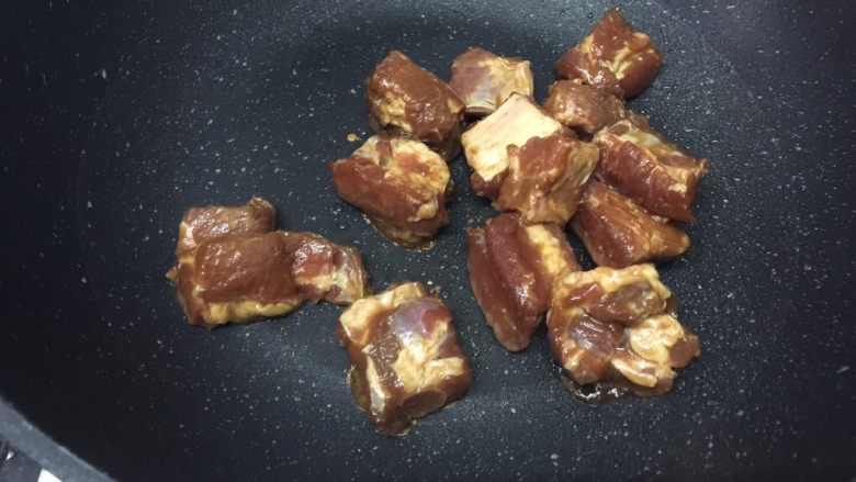 栗子焖排骨,用筷子把排骨夹放进锅里,不要把汁倒进去