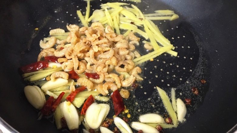酸辣白菜木耳炒虾米,倒入小虾米,翻炒