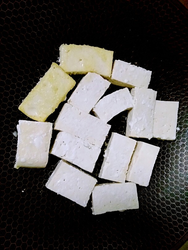 糖醋豆腐,锅里烧热,放入少许油,再下豆腐慢火煎。