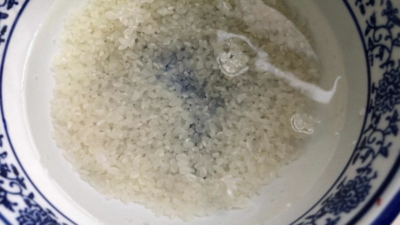 健康美味红薯绿豆大枣粥,抓两把米,清水冲洗三遍后,撇去洗米水。