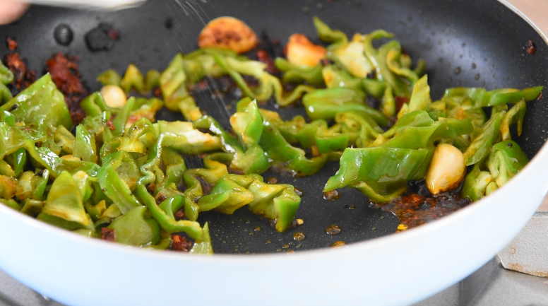 厨师长拿手菜,农家回锅肉,必吃三大碗饭!,炒出香气后,倒入青椒,加入1g盐调味