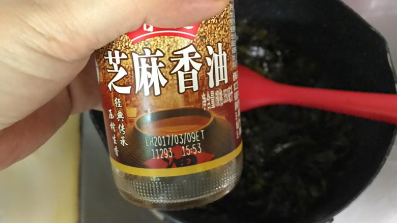 凉拌海藻,加入香油拌匀,因为加了酱油和醋有水分,一定要将海藻炒到水份都蒸发了才能熄火。
