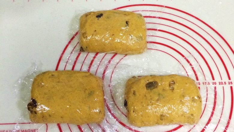 南瓜软欧包,折叠后盖好保鲜膜,静置松弛15分钟。