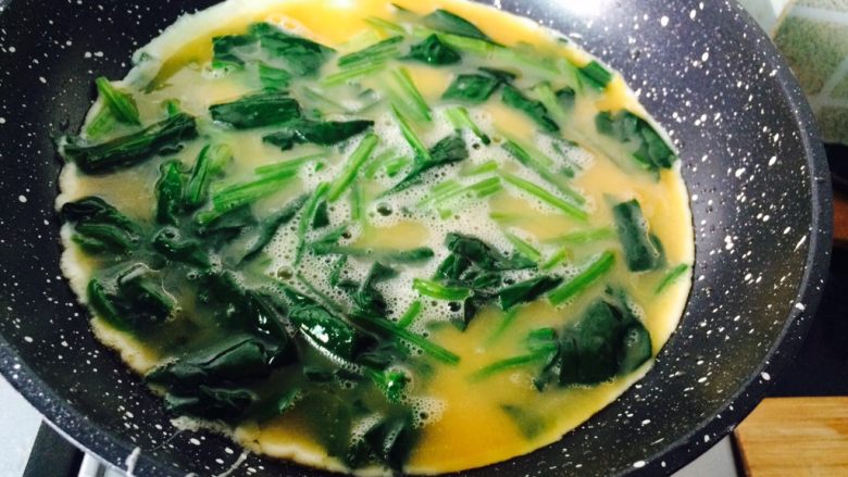 阳光下的暗送秋波—鸡蛋菠菜饼,倒入鸡蛋菠菜混合液,用小火加热。