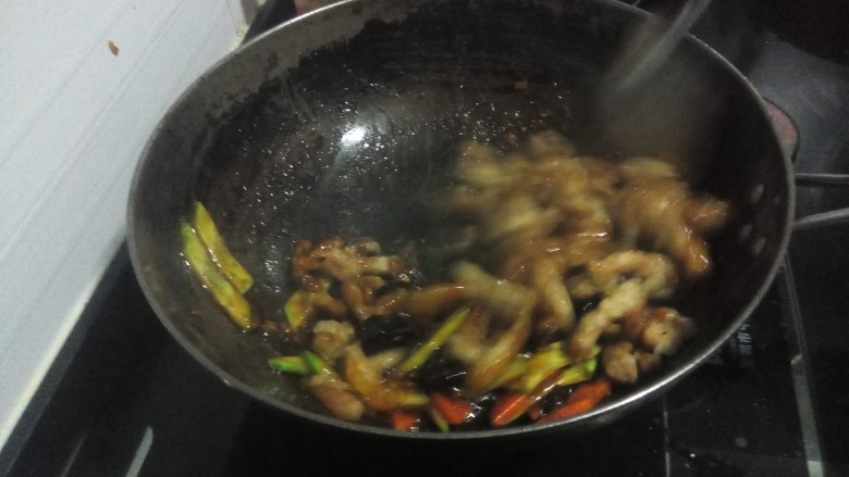 糖醋 里脊,下入肉条,焯烫过的食材和黄瓜,大火翻炒均匀