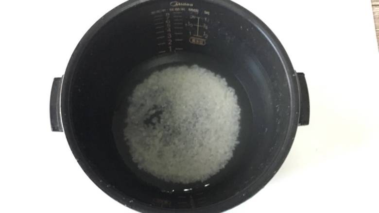 芹菜瘦肉粥,1.大米洗净,加适量水,放到电饭煲里熬成粥。有时间的妈妈可以用砂锅煲粥。
PS: 大家用家里平时习惯的方法煮粥就好,我图方便就用了电饭煲熬粥。熬粥最好不要把食材与米粥一起煮熟,汤容易变浑浊,粥也不粘稠,菜容易煮烂,熬出来的口感和卖相都不是特别好。所以,我一般习惯于熬好了粥底和各种食材后,再混合在一起用锅熬煮一会儿。
