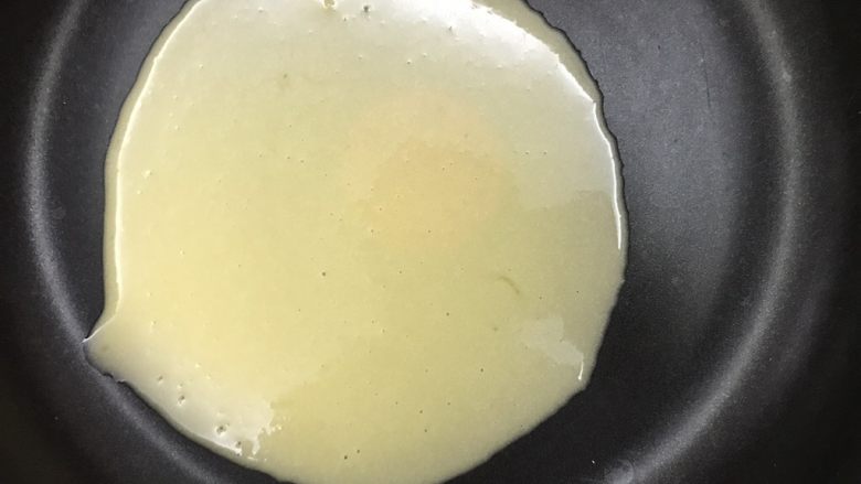 平底锅蛋筒卷,舀一勺面糊到锅里,晃动锅子让面糊均匀摊开,尽量薄一些