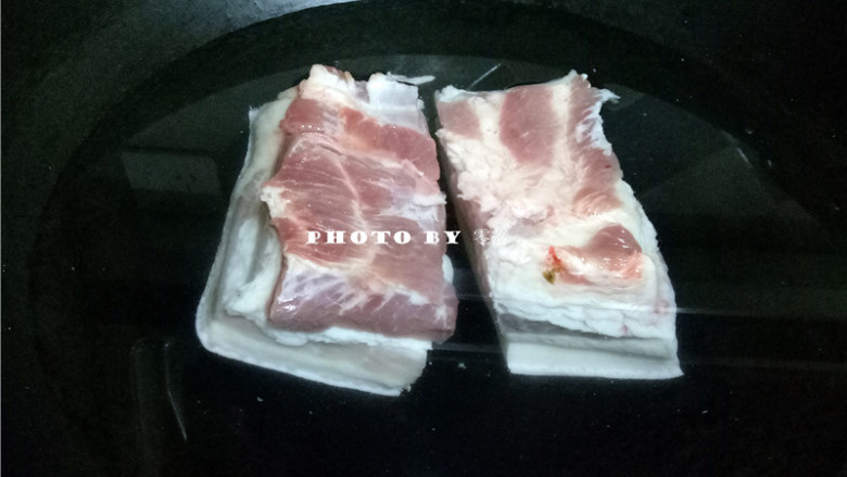 四川烧白,五花肉刮洗干净,放入煮锅,倒入适量清水煮熟;