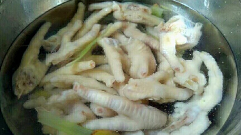 泡凤爪,鸡爪泡清水中,洗去浮沫。