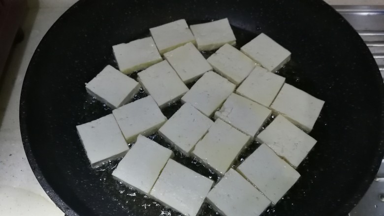 糖醋豆腐,油温八成热时,放入切好的豆腐块,大火煎2分钟左右至底部金黄