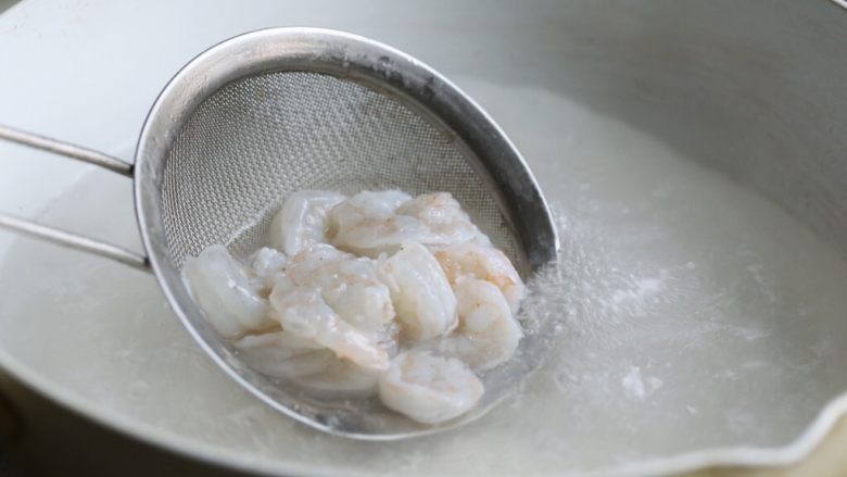 缤纷虾仁蛋炒饭,将虾也放入热水中焯至变色,迅速捞起,沥水备用。