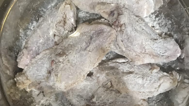 金沙蛋黄鸡翅,把鸡翅吸干水分,撒上生粉,把鸡翅包裹