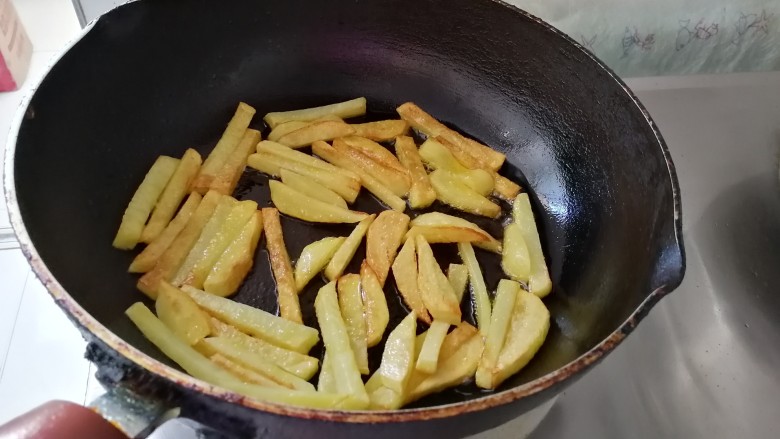 腊肠炒土豆条蒜苔,土豆 条煎至金黄色,煎熟了。